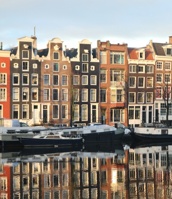 Gracht met grachtenpanden en boten ervoor